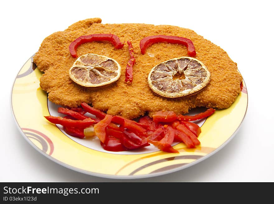 Escalope breaded with paprika patrols onto plates