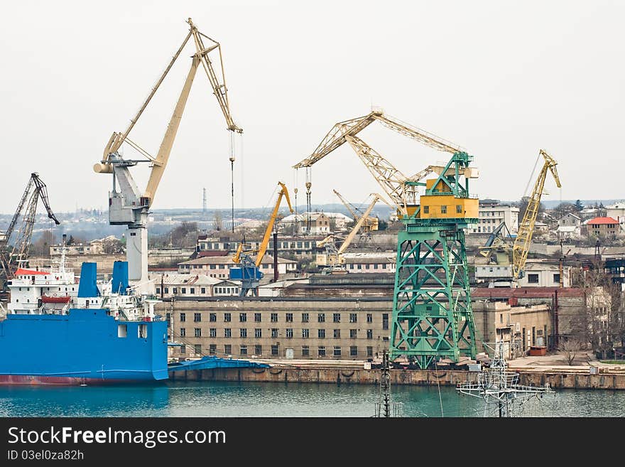 Powerful shipbuilding shipyard with a pier and cranes