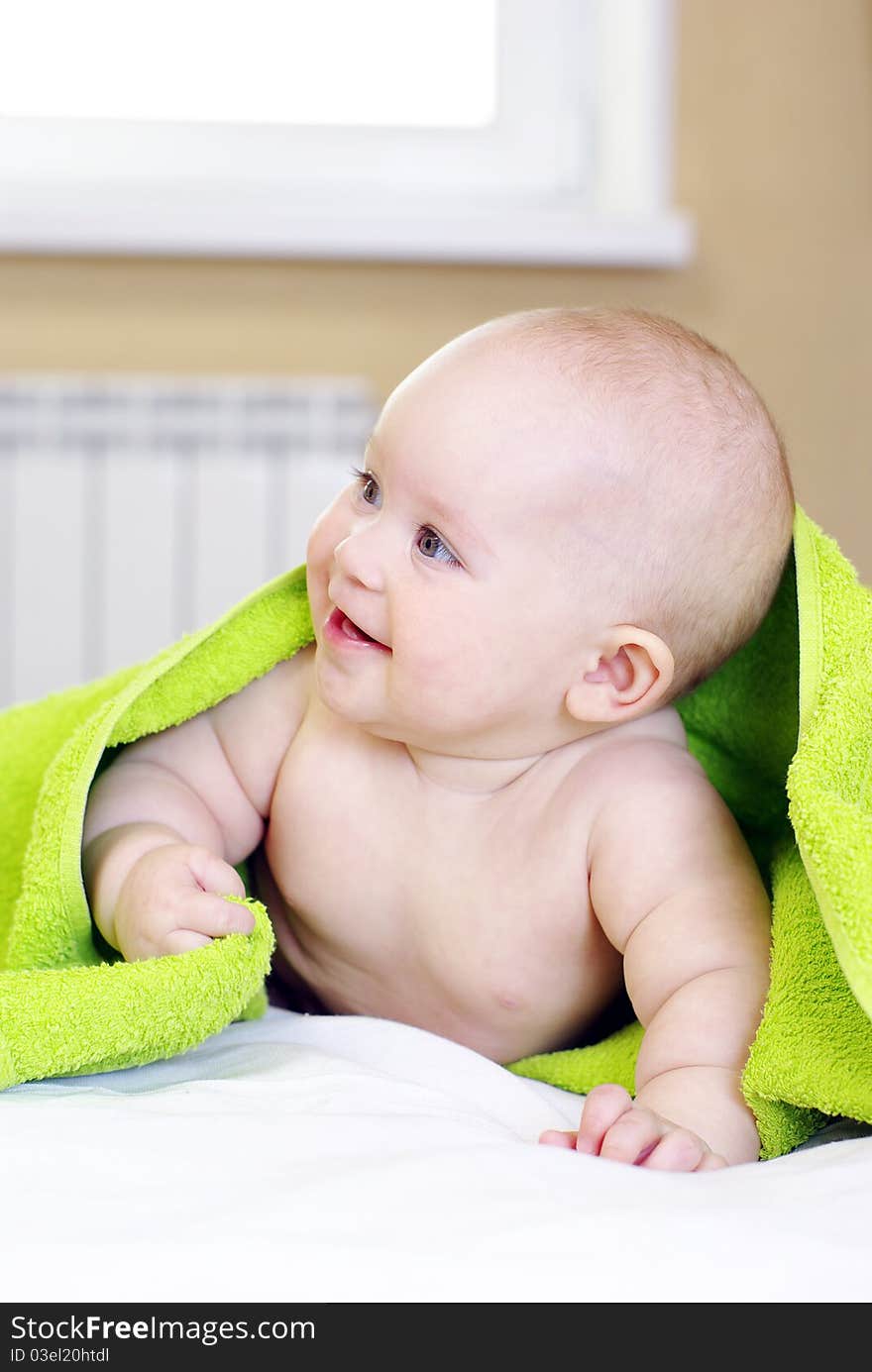 Happy smiling baby girl on bed after bath. Happy smiling baby girl on bed after bath.