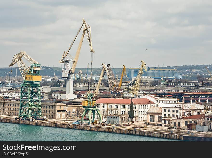 Powerful shipbuilding shipyard with a pier and cranes