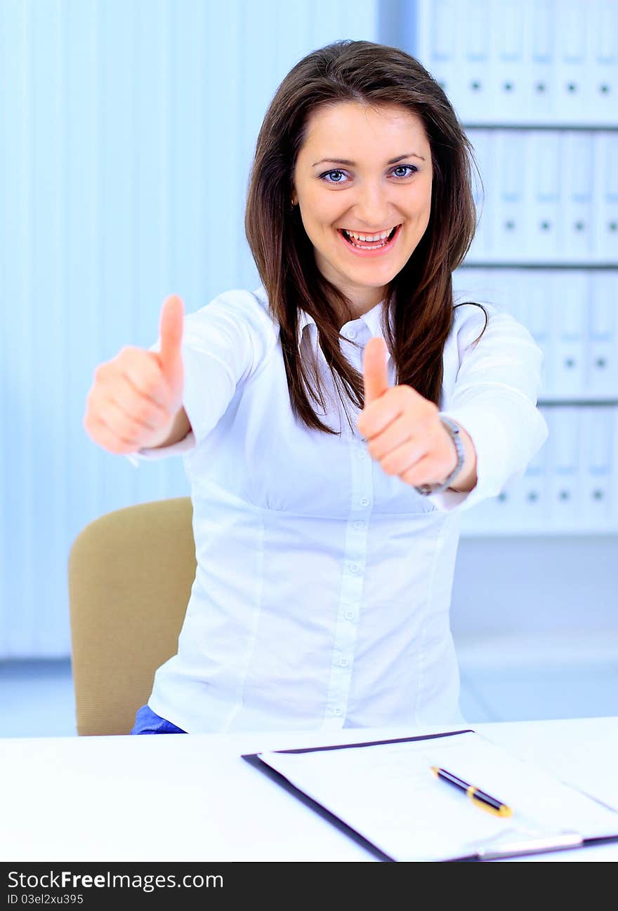 Business woman shows thumb up. Business woman shows thumb up