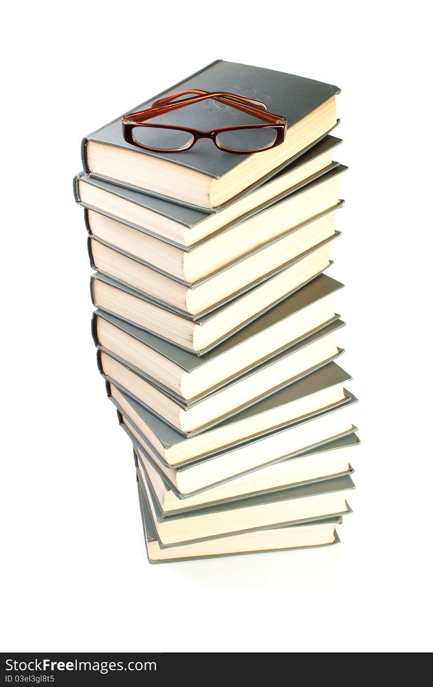 Stack of books and eyeglasses isolated on the white