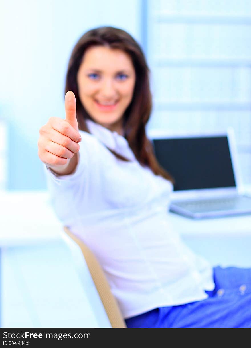 Smiling business women holding the thumbs up. Smiling business women holding the thumbs up