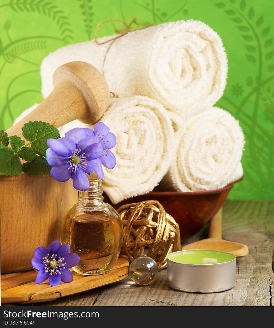 Spa setting: towels, flowers, candles and oil