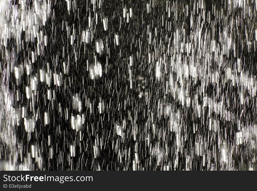 Back-lite water-drops in a waterfall