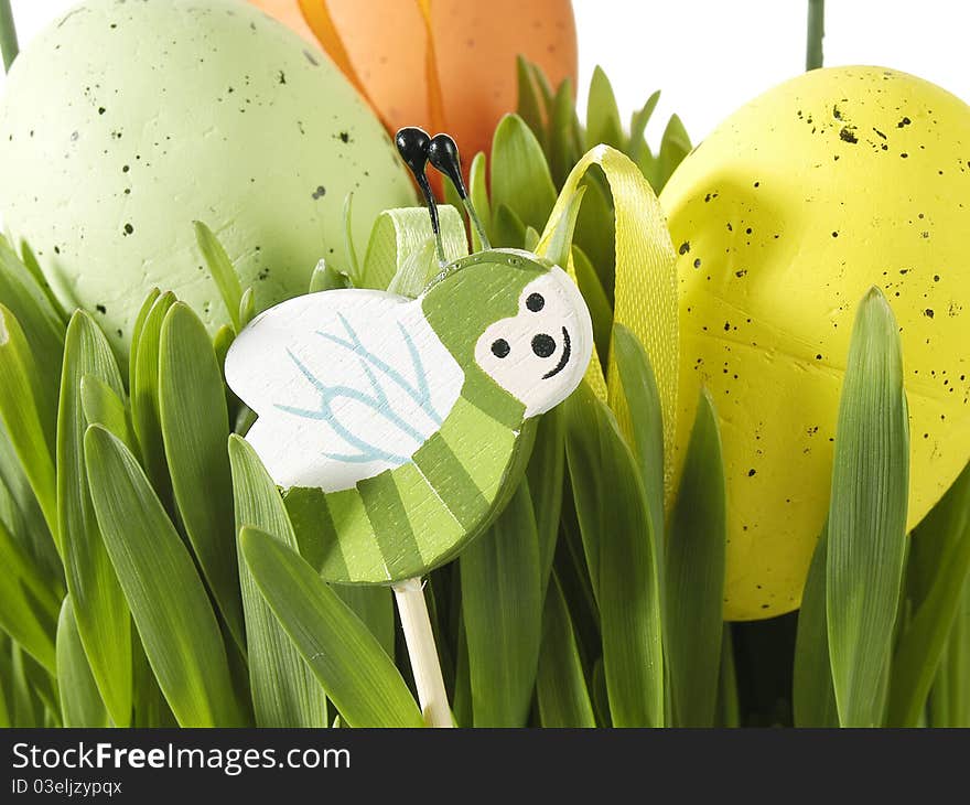 Colorful traditional Easter decoration with grass and artificial eggs