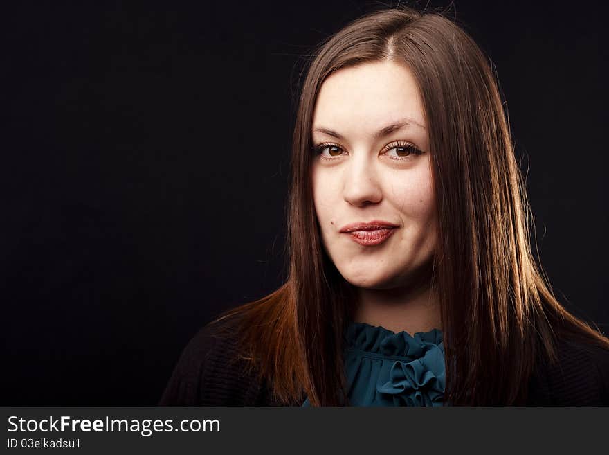 Portrait of an ironic woman on black background. Close-up. Portrait of an ironic woman on black background. Close-up.