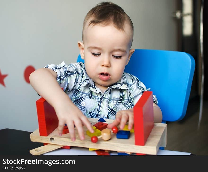 Little boy playing with wooden toy. Little boy playing with wooden toy