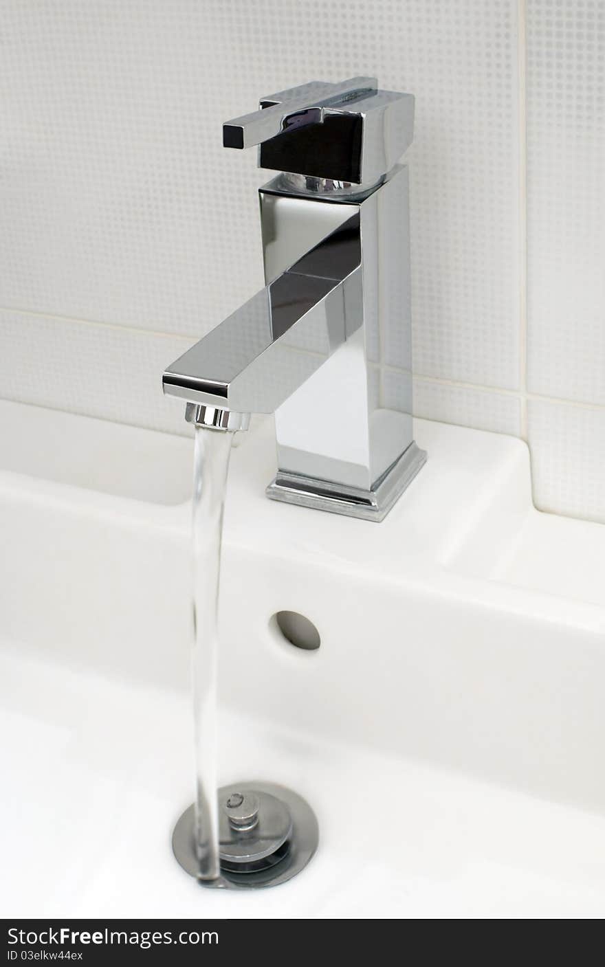 Closeup of modern bathroom tap, flowing tap water