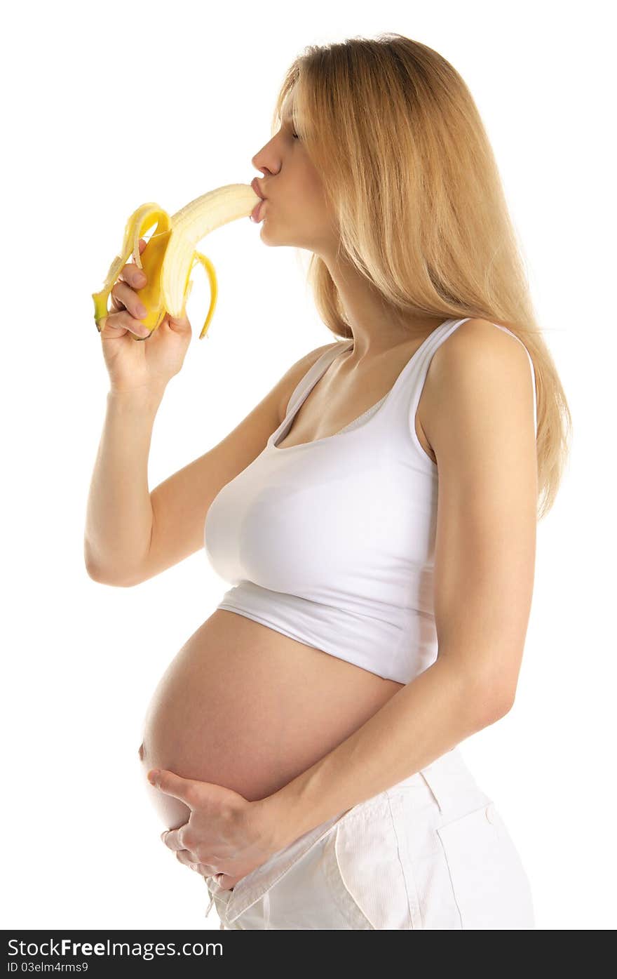 Pregnant woman is sexually bites banana isolated on white