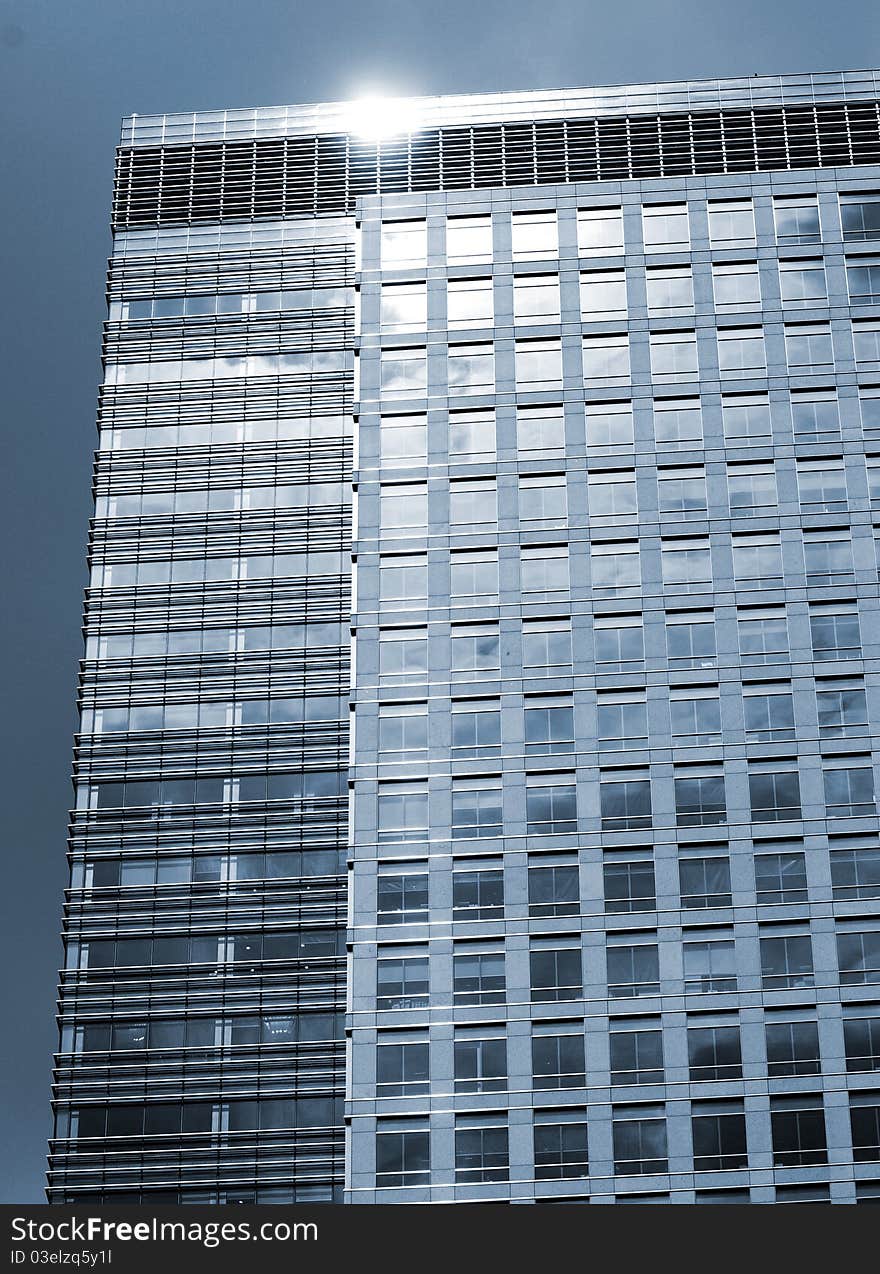 The upper facade of a large london skyscraper building. The upper facade of a large london skyscraper building