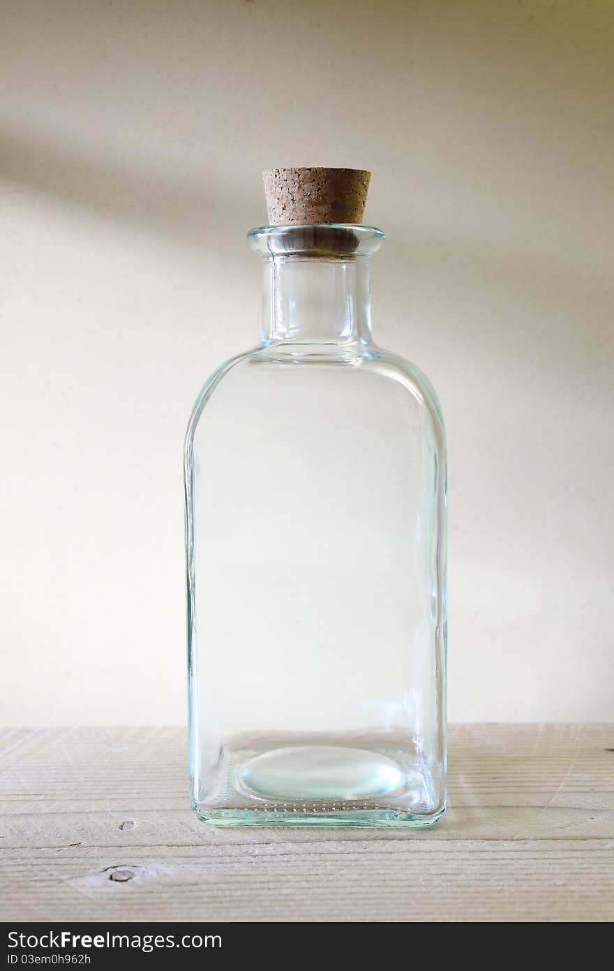 Old glass bottle on wooden shelf