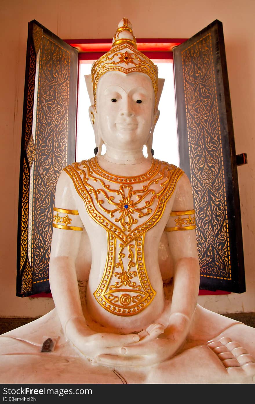 White buddhist monk statue with window light at the back. White buddhist monk statue with window light at the back