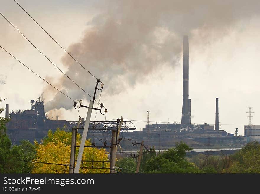 Large metallurgical factory destroying the nature with smoke and waste. Large metallurgical factory destroying the nature with smoke and waste