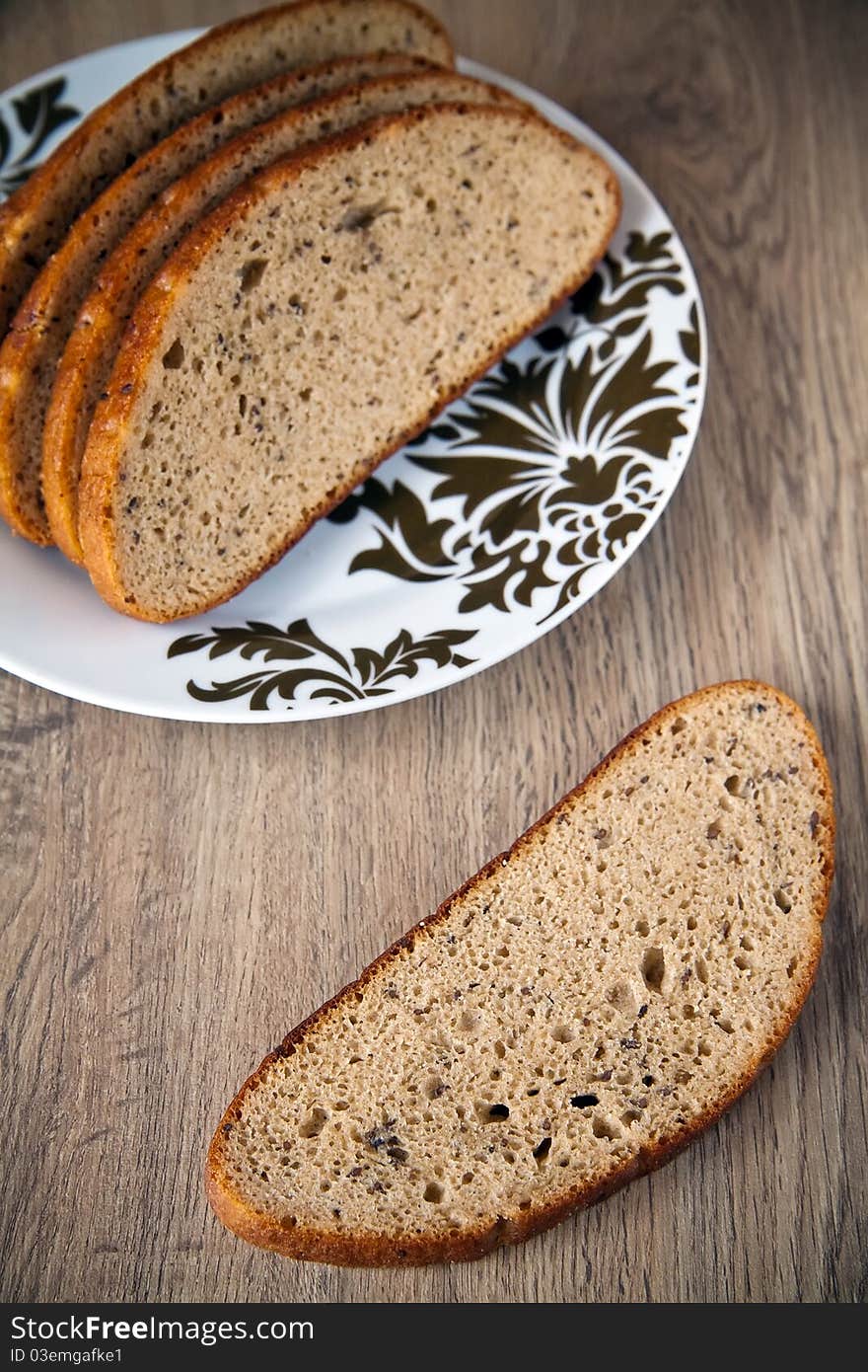 Close-up cut grey bread with cumin on a plate