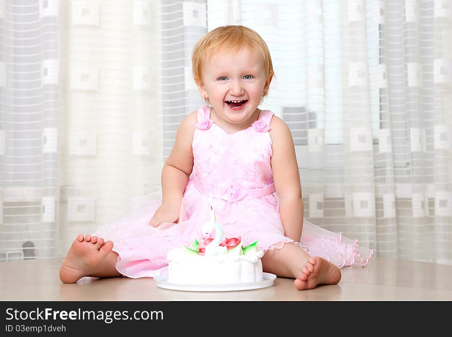 Girl enjoying her first birthday cake. Girl enjoying her first birthday cake