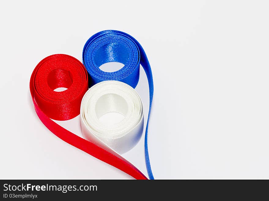 Red white and blue ribbon in shape of a heart. Red white and blue ribbon in shape of a heart