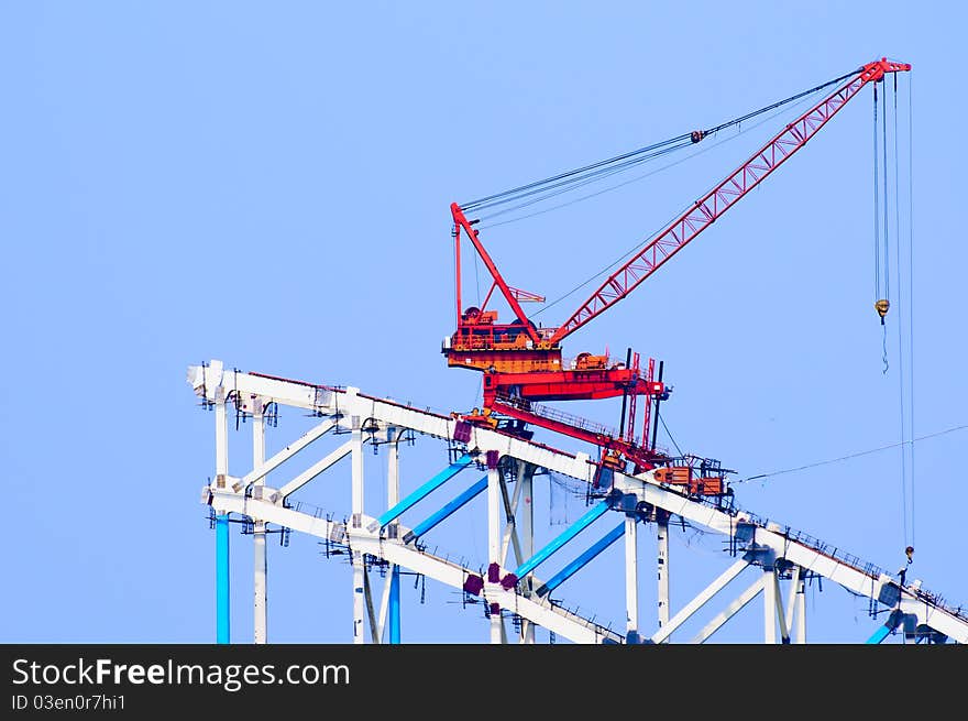 The working crane in the blue sky