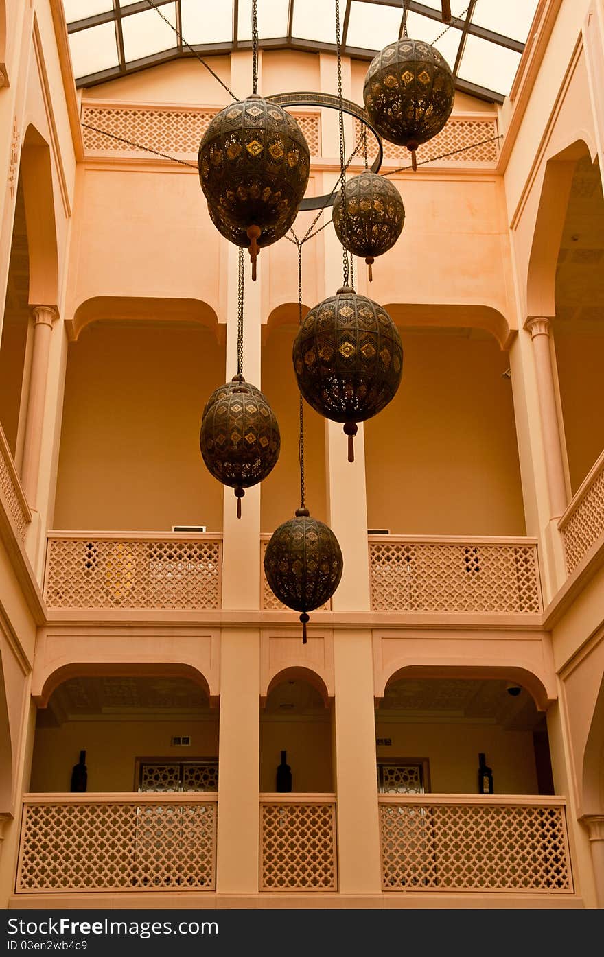 Exotic Arabian lanterns hang in the atrium of a building.