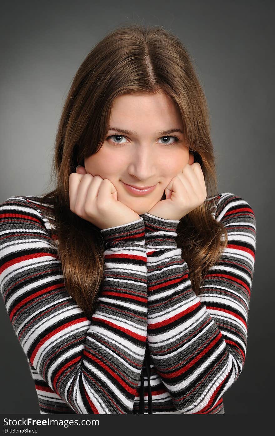 Portrait of the attractive woman on a grey background. Portrait of the attractive woman on a grey background