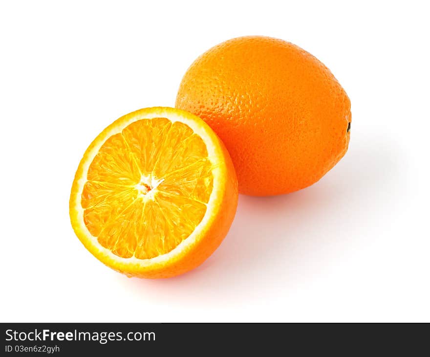 Whole and half cut oranges isolated on white background