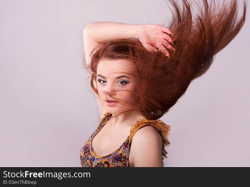 Portrait of a pretty girl with hair fluttering in the wind