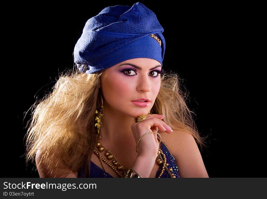 Beautiful girl in a turban and a stylized ethnic costume