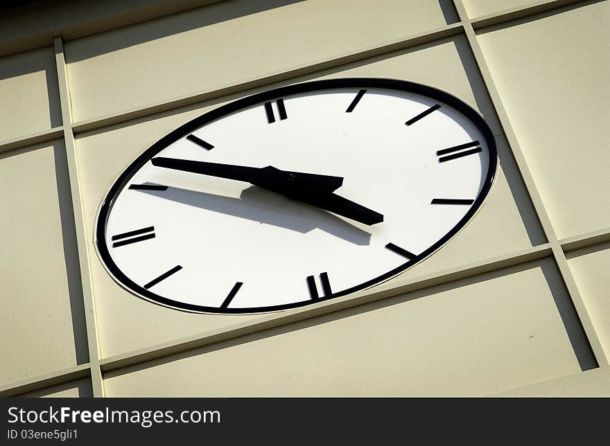 Close up of face of modern clock on side of building. Close up of face of modern clock on side of building