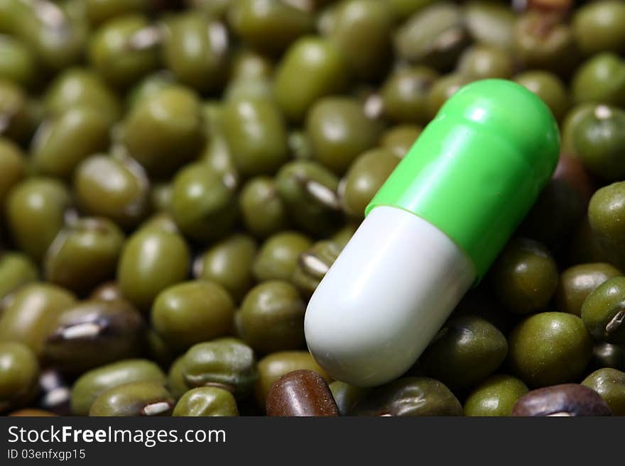 Natural vitamin pill on green beans. Natural vitamin pill on green beans.