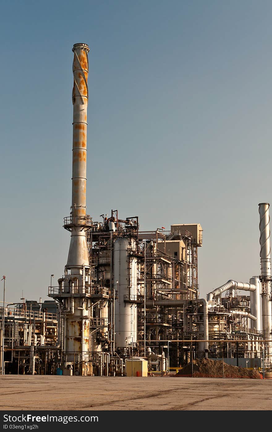 A petrochemical refinery plant with pipes and cooling towers