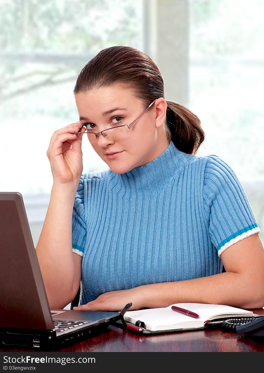 Beautiful businesswoman working with laptop at her office