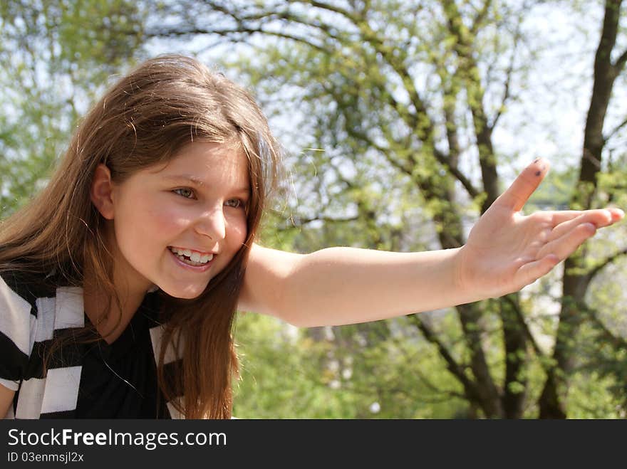 Young girl pointing with her arm towards something. Young girl pointing with her arm towards something