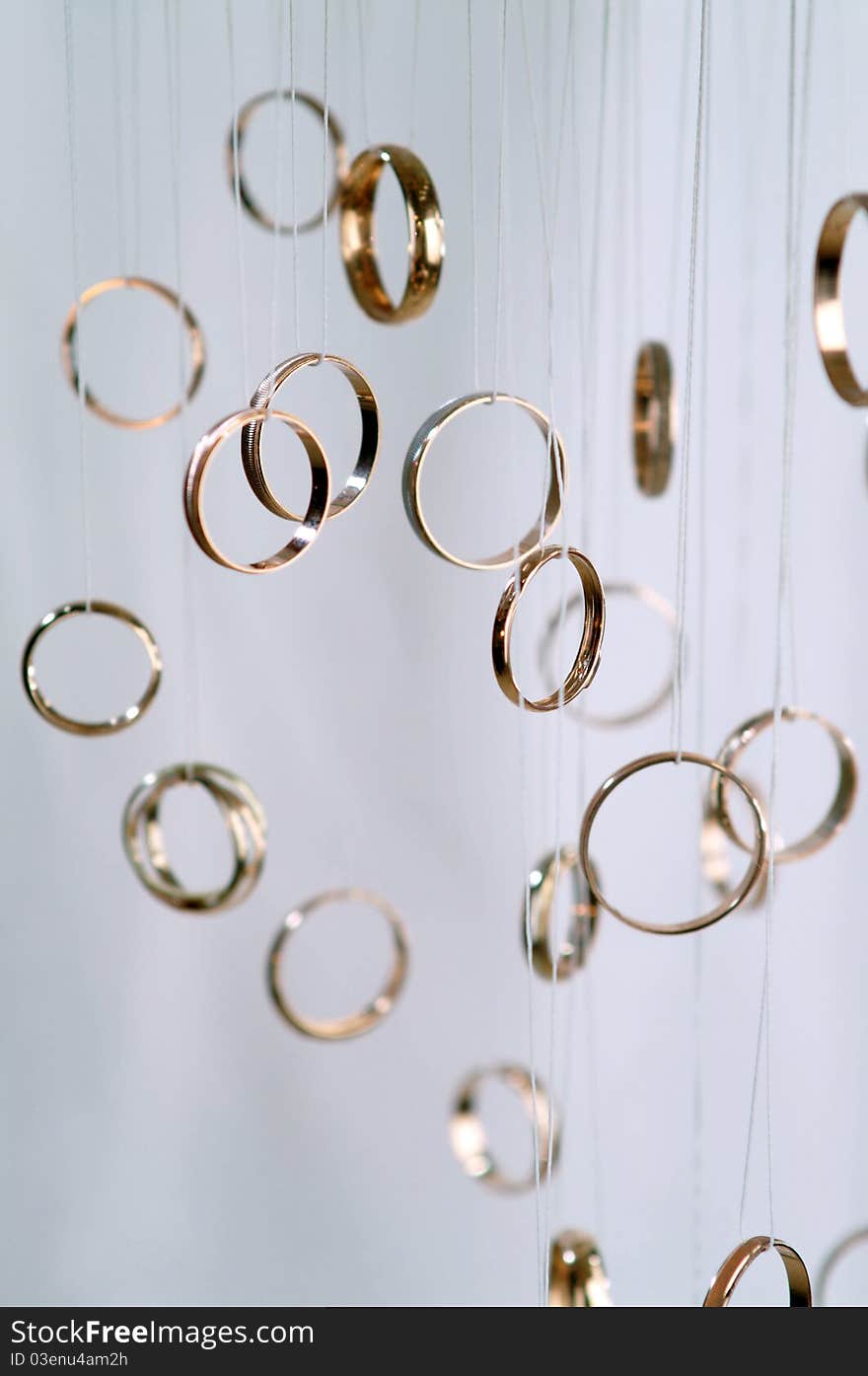 Several gold rings on a light background