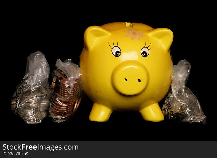 Yellow piggybank with sterling money