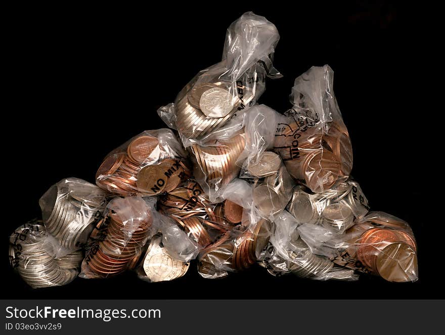 Pile of sterling coins in money bags studio cutout
