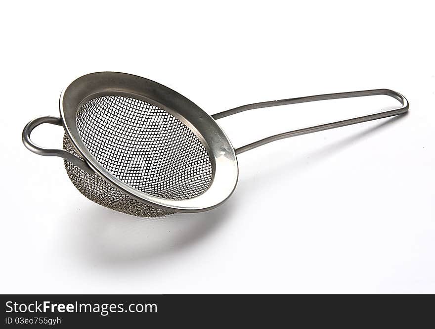 Metal tea strainer on the white background