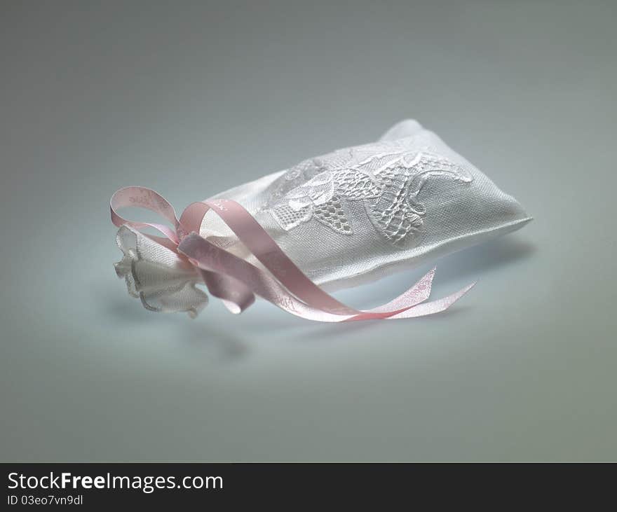 A small bag with a pink ribbon