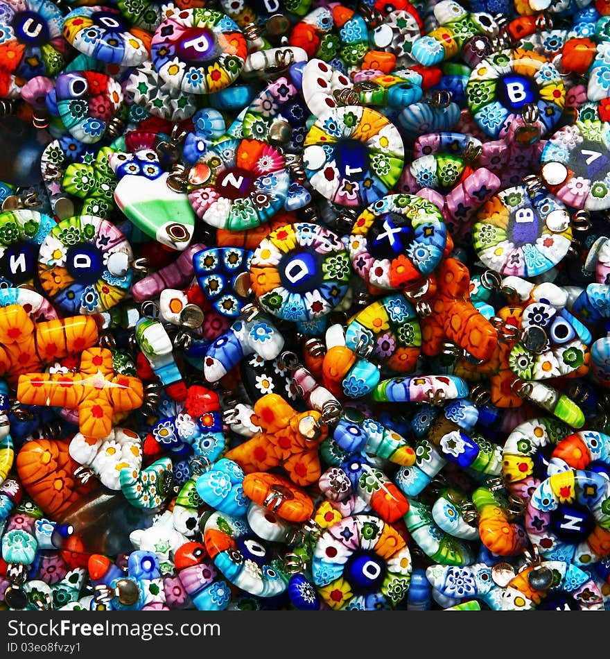 Glass and plastic bright colorful costume jewellery on a street market table. Good for background. Glass and plastic bright colorful costume jewellery on a street market table. Good for background.