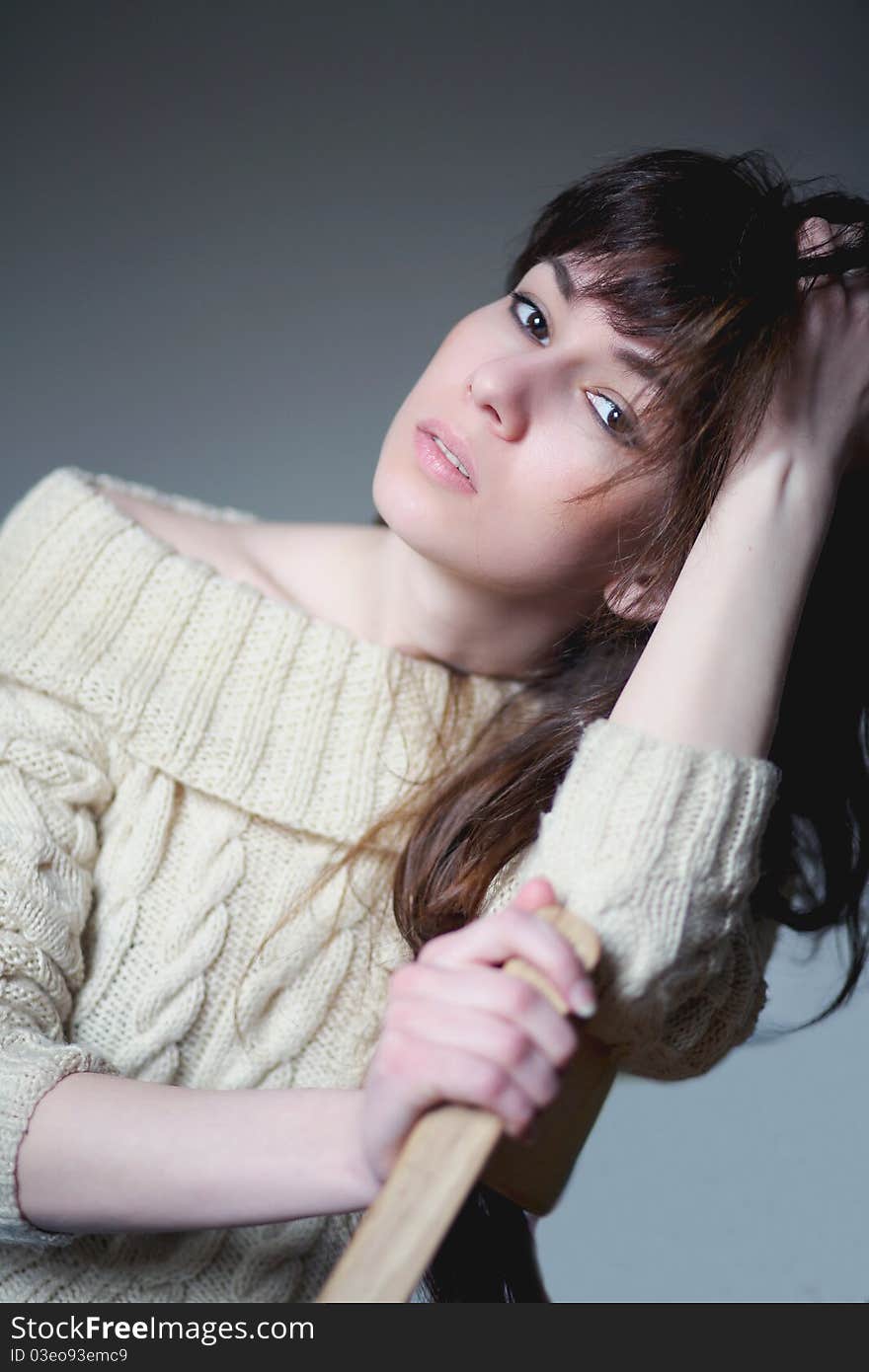 Brunette sitting on a chair. Brunette sitting on a chair