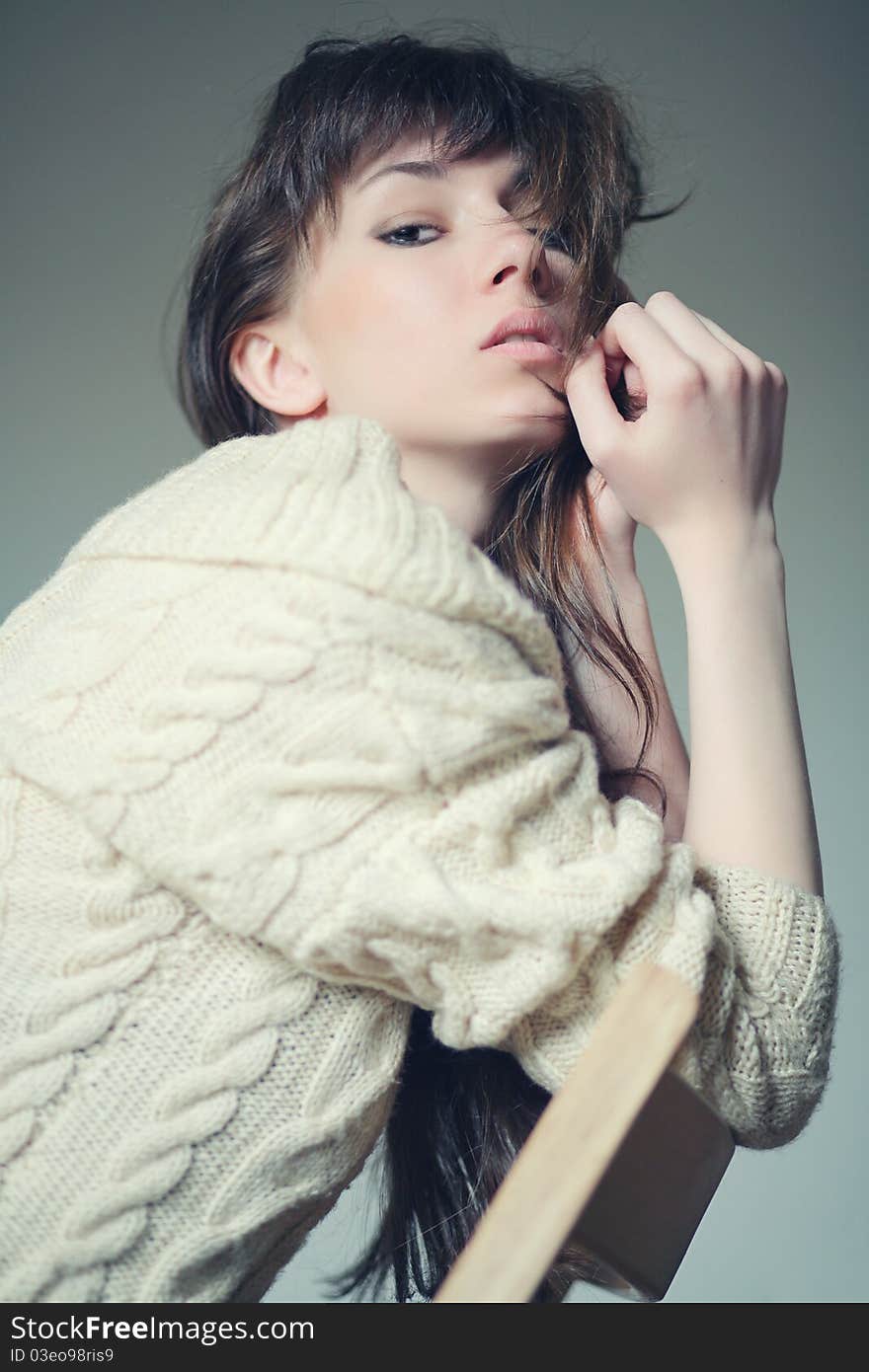 Brunette sitting on a chair. Brunette sitting on a chair