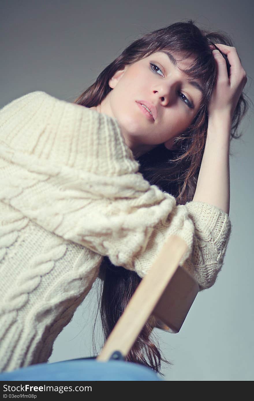 Brunette sitting on a chair