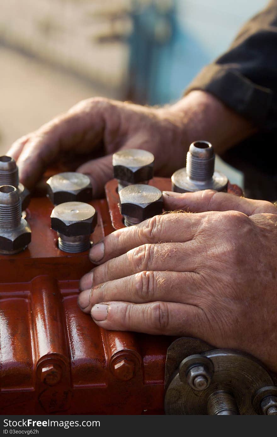 Worker put his hands on the engine