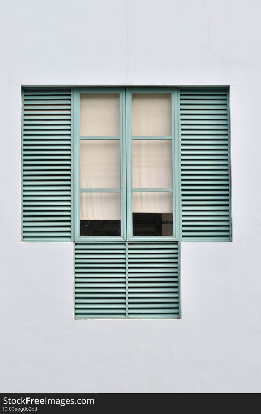 Window in light green color with wooden grid and simple white cloth curtain. Window in light green color with wooden grid and simple white cloth curtain.