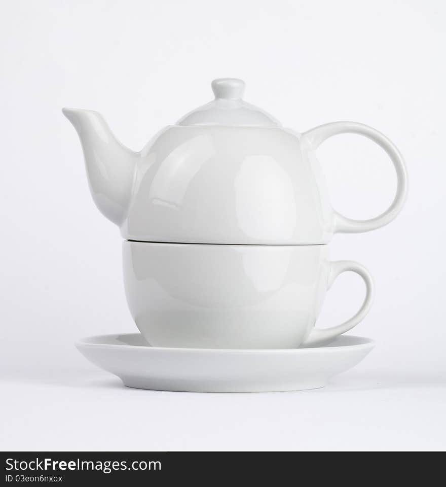 White cup of tea with teapot. White cup of tea with teapot