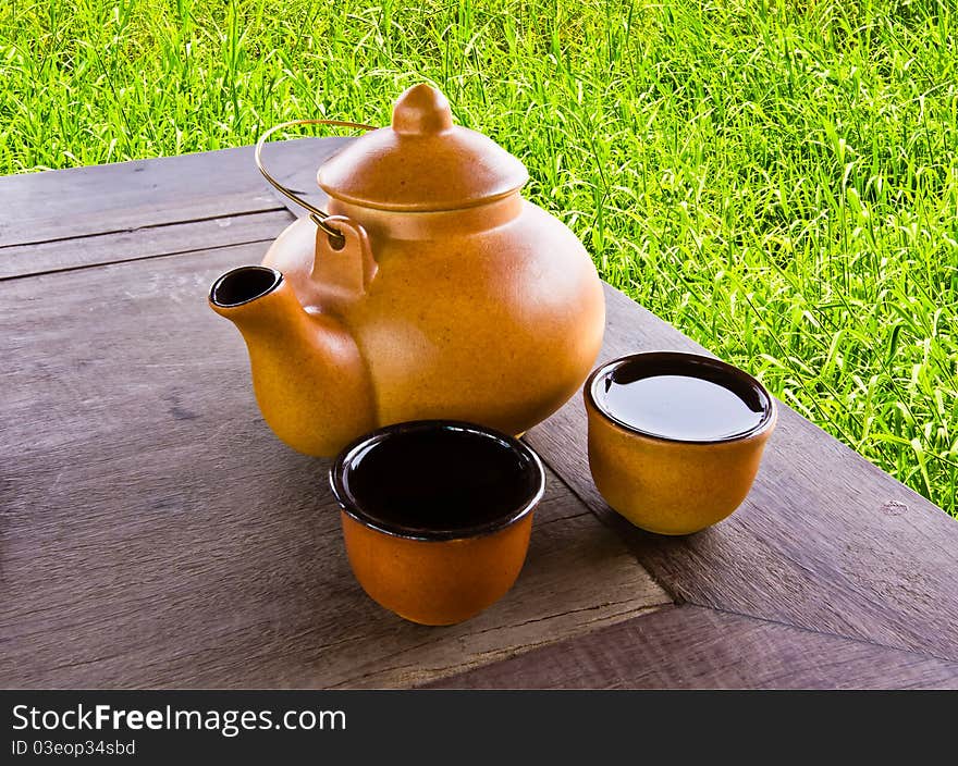 Earthenware tea pot with two cups