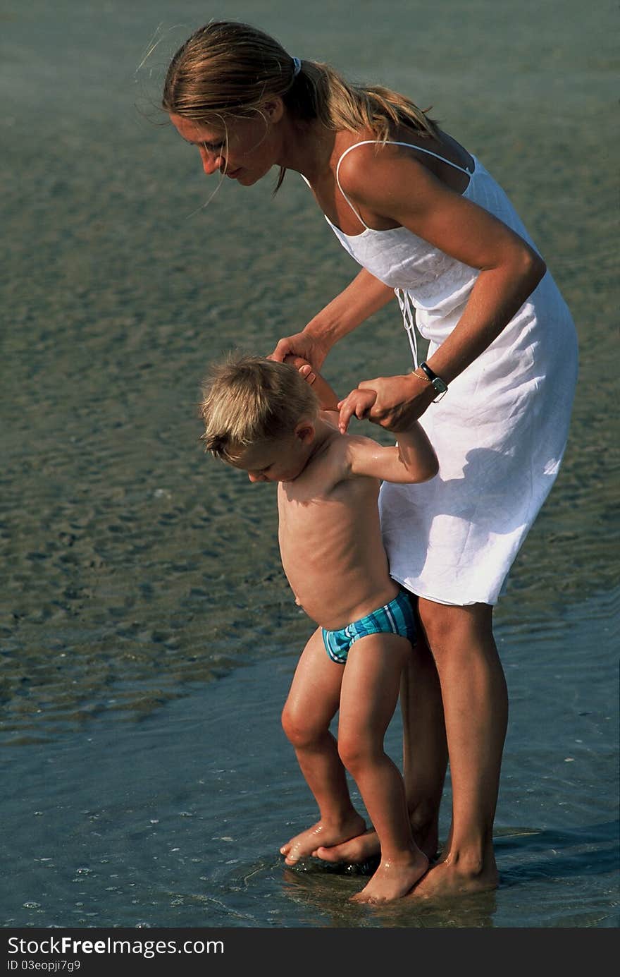 Young woman with her son walking on water. Young woman with her son walking on water