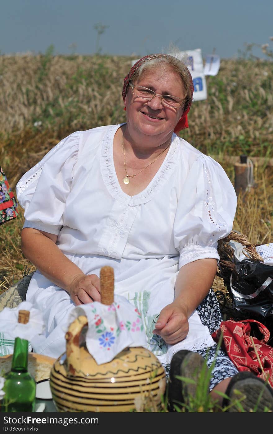 Traditional breakfast in a field at the time of harvest. Hungarian folk costume. Traditional breakfast in a field at the time of harvest. Hungarian folk costume