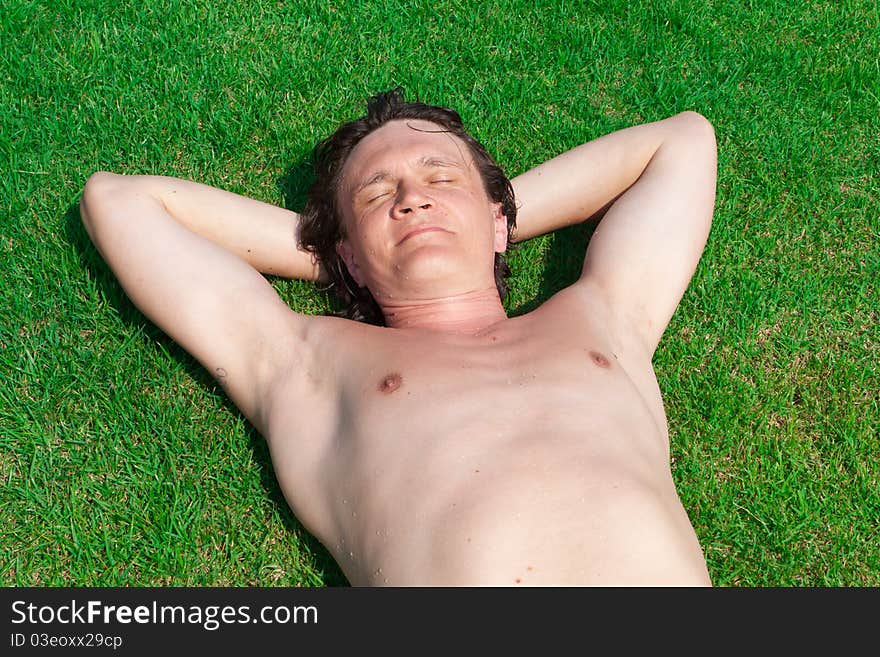 The Man Lies On A Grass