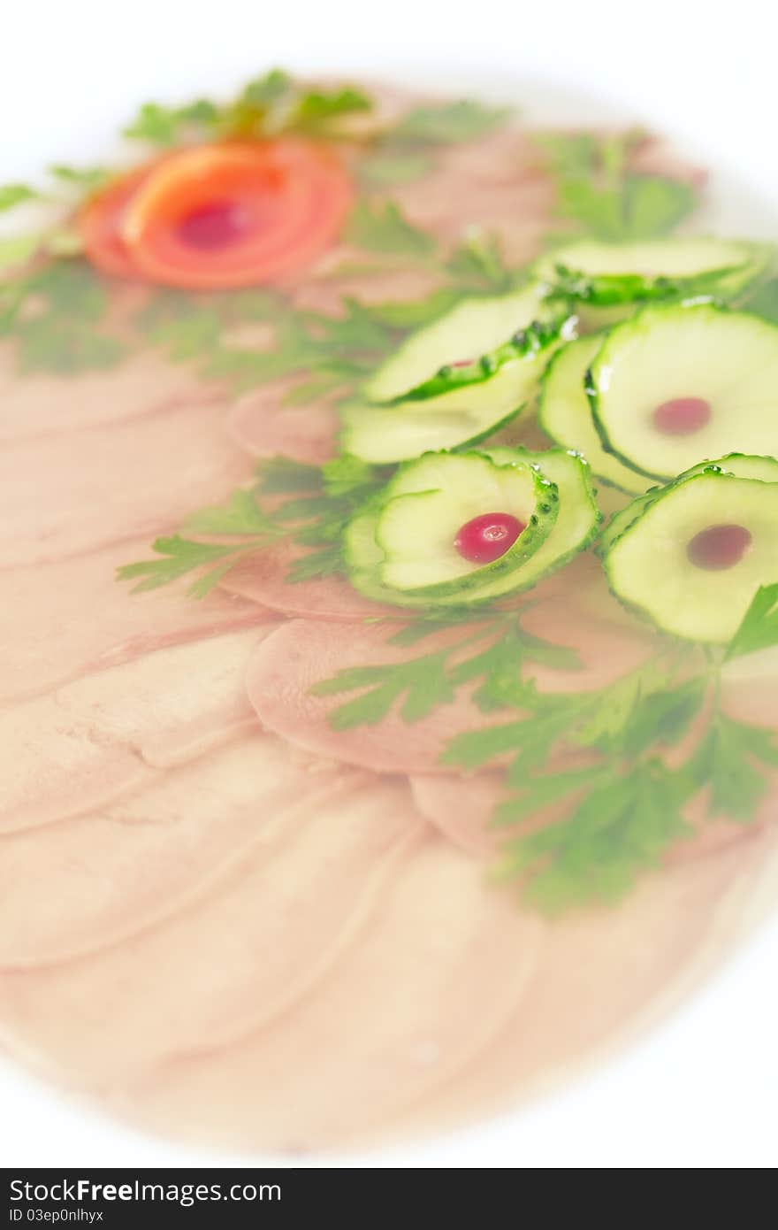 Aspic from meat decorated with  carrot, cucumber, pomegranate and  Parsley over white background. Aspic from meat decorated with  carrot, cucumber, pomegranate and  Parsley over white background