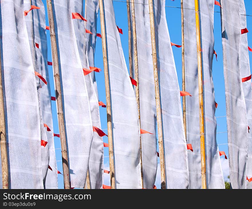 White large prayer flags over a clear blue sky